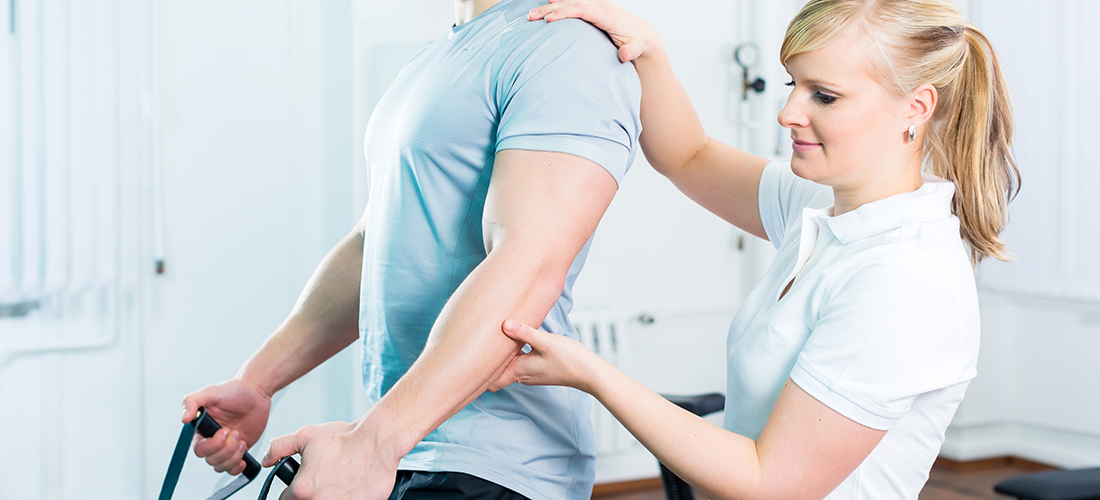Physiotherapist excercising patient in practice